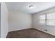 Bedroom with neutral carpet and a window providing natural light at 6708 Bedford Rd, Rex, GA 30273