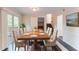 Elegant dining room featuring a large wooden table with seating for six and sliding glass doors at 6708 Bedford Rd, Rex, GA 30273