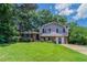 Charming home featuring a well-maintained lawn and beautiful mature trees offering nice shade at 6708 Bedford Rd, Rex, GA 30273