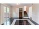 Bright living room with stairs, closet, and sliding glass doors to the outdoor deck at 6708 Bedford Rd, Rex, GA 30273