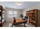 Comfortable home office with built-in bookshelves and a large desk, perfect for remote work at 6708 Bedford Rd, Rex, GA 30273