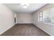 Spacious empty room with neutral walls, plush carpeting, and a large window with natural light at 6708 Bedford Rd, Rex, GA 30273