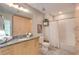 Bright bathroom with granite countertops, wooden cabinets, and shower-tub combo at 943 Peachtree Ne St # 814, Atlanta, GA 30309