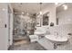 Elegant bathroom featuring double sinks, stylish gray tile flooring, and a large, tiled walk-in shower at 943 Peachtree Ne St # 814, Atlanta, GA 30309