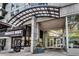 Modern building entrance with glass doors, planters, and 'Sweet Hut' cafe at 943 Peachtree Ne St # 814, Atlanta, GA 30309