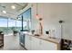 Well-appointed kitchen features a bar sink, mini-fridge, and seamless transition to the inviting living area at 943 Peachtree Ne St # 814, Atlanta, GA 30309
