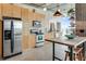 Bright kitchen boasts stainless appliances, light wood cabinetry, and a breakfast bar with seating at 943 Peachtree Ne St # 814, Atlanta, GA 30309