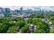 Aerial view of a neighborhood surrounded by lush greenery, with the Atlanta skyline in the background at 1190 Francis Nw St, Atlanta, GA 30318