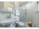 A full bathroom with pedestal sink, toilet, and glass-enclosed shower with white tiling at 1190 Francis Nw St, Atlanta, GA 30318