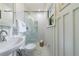 Bathroom featuring a glass-enclosed shower, pedestal sink, and stylish white tiling and paneling at 1190 Francis Nw St, Atlanta, GA 30318