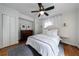This bedroom features hardwood floors, a ceiling fan, a dresser and a bed with white linens at 1190 Francis Nw St, Atlanta, GA 30318