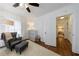 Bedroom with a comfortable armchair, crib, and storage unit near the closet at 1190 Francis Nw St, Atlanta, GA 30318