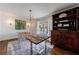 Dining room boasting a rustic table, modern chandelier, and a large antique sideboard at 1190 Francis Nw St, Atlanta, GA 30318