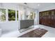 Welcoming entryway featuring large windows, a stylish cabinet, and an antique rug on white floors at 1190 Francis Nw St, Atlanta, GA 30318