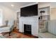 Cozy fireplace with mantel and built-in bookshelves, flanked by comfortable chairs at 1190 Francis Nw St, Atlanta, GA 30318