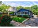 Blue home with lush landscaping, green lawn, and stone walkway, offering great curb appeal at 1190 Francis Nw St, Atlanta, GA 30318
