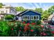 Charming blue home with vibrant red rose bushes, lush green lawn, and inviting curb appeal at 1190 Francis Nw St, Atlanta, GA 30318