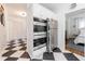 Kitchenette features stainless appliances and black and white tile adjacent to a bedroom at 1190 Francis Nw St, Atlanta, GA 30318