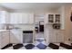 Bright kitchen with white cabinets, modern appliances, and striking black-and-white checkered flooring at 1190 Francis Nw St, Atlanta, GA 30318