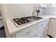 Kitchen features a gas range, white cabinets, and marble countertops at 1190 Francis Nw St, Atlanta, GA 30318
