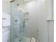 A glass enclosed shower featuring a built-in shelf and sleek white tile at 1190 Francis Nw St, Atlanta, GA 30318