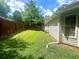 A spacious backyard with a lush green lawn, surrounded by a wooden fence at 148 Parkside Dr, Stockbridge, GA 30281