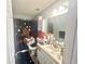 Bathroom featuring tiled floors, a vanity sink, and a shower and tub combo at 148 Parkside Dr, Stockbridge, GA 30281