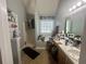 Primary bathroom featuring a garden tub, shower, and vanity with storage at 148 Parkside Dr, Stockbridge, GA 30281
