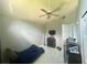 Cozy bedroom with a ceiling fan, sloped ceiling, and light-filled window at 148 Parkside Dr, Stockbridge, GA 30281