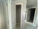 Hallway includes tile floors and doors for closets and entryways throughout the house at 148 Parkside Dr, Stockbridge, GA 30281