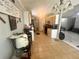 Galley kitchen with tile floors, wood cabinets, and access to living spaces at 148 Parkside Dr, Stockbridge, GA 30281