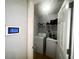 Laundry room features modern washer and dryer, security system and overhead lighting at 148 Parkside Dr, Stockbridge, GA 30281
