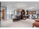Open basement area featuring a cozy sitting area, desk, exercise bike, and neutral carpet at 200 Mystic Ct, Atlanta, GA 30342