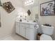 Clean bathroom with a white vanity, a decorative mirror, and contemporary lighting at 200 Mystic Ct, Atlanta, GA 30342