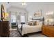 Bright bedroom with vaulted ceiling, striking dark metal bed frame, and neutral decor at 200 Mystic Ct, Atlanta, GA 30342