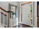 Bright foyer with wood floors, staircase, transom window above door, and decoratively adorned console table at 200 Mystic Ct, Atlanta, GA 30342