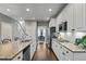 Open kitchen featuring white cabinets, granite countertops, and stainless steel appliances, with access to dining room at 200 Mystic Ct, Atlanta, GA 30342