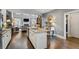 Open kitchen with stainless steel appliances, granite counters, and hardwood floors flows into the living room at 200 Mystic Ct, Atlanta, GA 30342