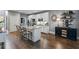 Well-lit kitchen featuring a granite island, white cabinets, hardwood floors, and stainless steel appliances at 200 Mystic Ct, Atlanta, GA 30342