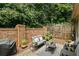 Cozy outdoor patio with a brick wall, comfortable seating, and lush greenery at 200 Mystic Ct, Atlanta, GA 30342