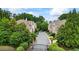 Street view showcases the gated community, lush landscaping, and well-maintained homes at 200 Mystic Ct, Atlanta, GA 30342