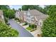 Elevated street view highlights the beautiful townhomes with manicured lawns and mature trees lining the street at 200 Mystic Ct, Atlanta, GA 30342