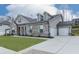 Charming home with a brick and siding exterior, a two-car garage, and a well-maintained front lawn at 449 Carmichael Cir, Canton, GA 30115