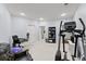 This basement space has neutral walls and carpet and includes a chair, desk and exercise equipment at 901 Abernathy Ne Rd # 5140, Sandy Springs, GA 30328