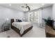 This bedroom has a large bed, a ceiling fan, and large windows with plenty of natural light at 901 Abernathy Ne Rd # 5140, Sandy Springs, GA 30328