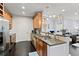 Functional kitchen showcasing dark hardwood floors, granite countertops, and stainless steel appliances at 901 Abernathy Ne Rd # 5140, Sandy Springs, GA 30328