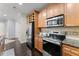 Kitchen featuring stainless steel appliances, granite countertops, and dark wooden cabinets at 901 Abernathy Ne Rd # 5140, Sandy Springs, GA 30328