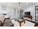 Cozy living area with dark hardwood floors, a comfortable sofa, and a large window for natural light at 901 Abernathy Ne Rd # 5140, Sandy Springs, GA 30328