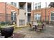 Outdoor patio with a stone fireplace, brick surround, and outdoor table and chairs at 901 Abernathy Ne Rd # 5140, Sandy Springs, GA 30328