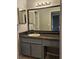 Bathroom featuring a vanity with granite countertop, large mirror, and storage space at 108 Countryside Se Pl, Smyrna, GA 30080